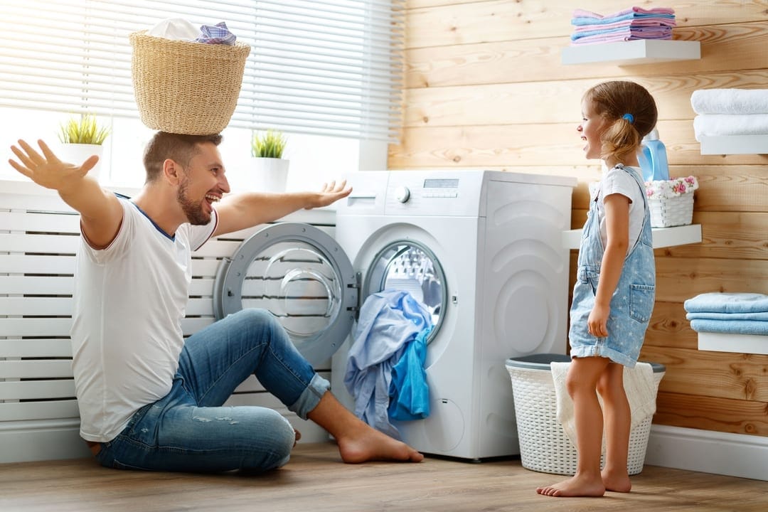 Dad and daughter in laundry room